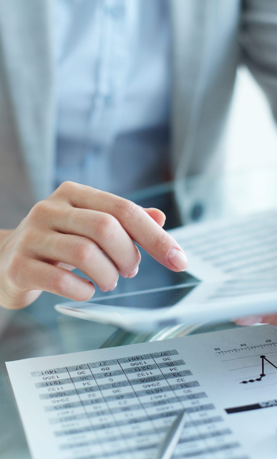 Close-up of young businesswoman hands working with touchpad